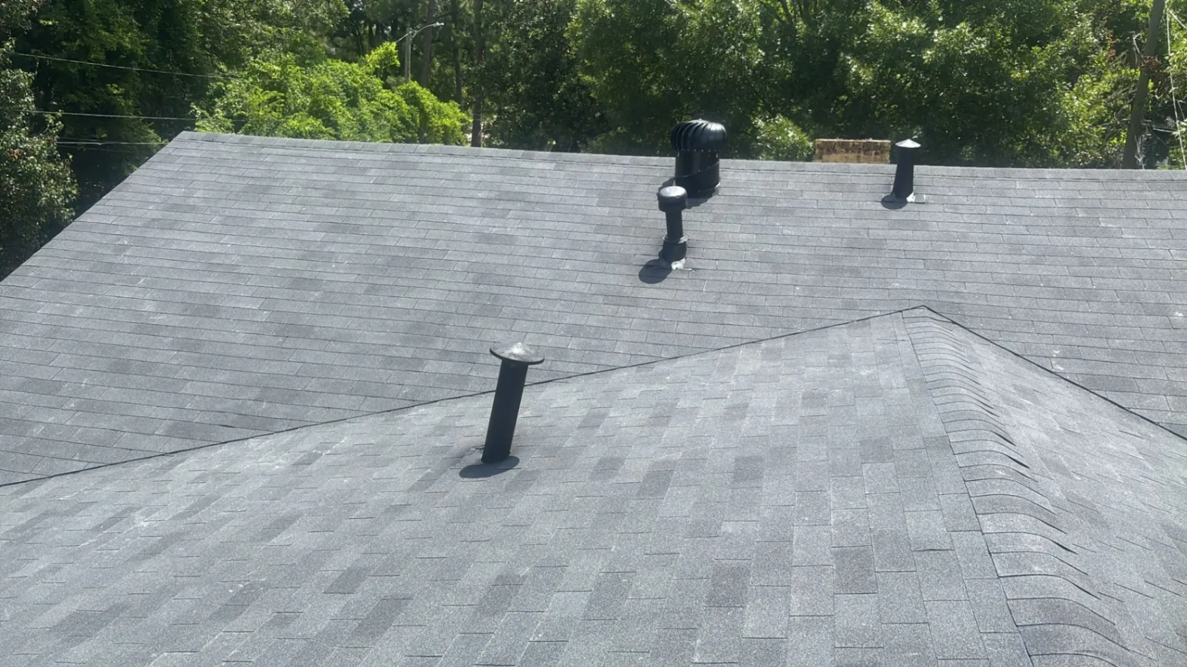 Shingle roof area being inspected for leak entry points